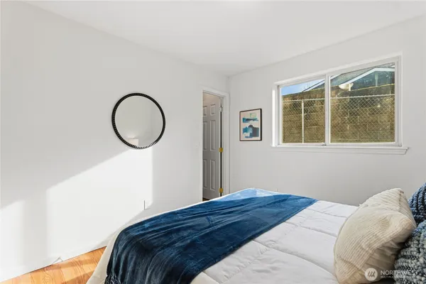 a bathroom with a sink a toilet a mirror and shower