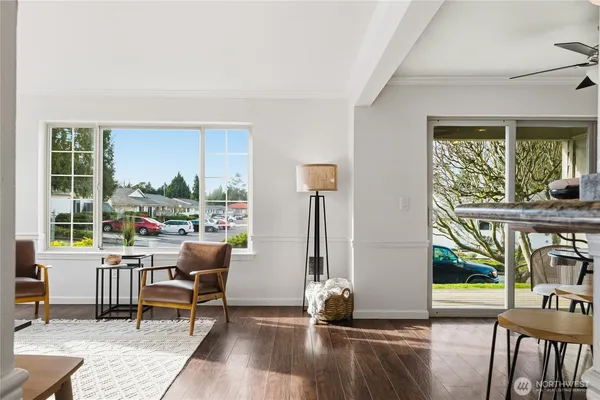 a living room with furniture a fireplace and a floor to ceiling window