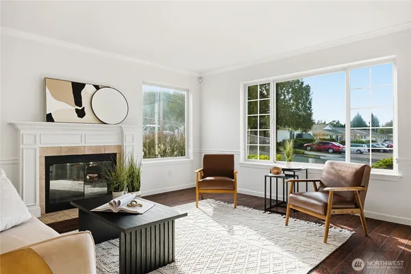 a living room with furniture a rug and a view of kitchen
