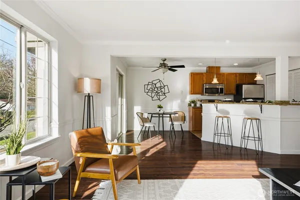 a living room with furniture fireplace and dining table
