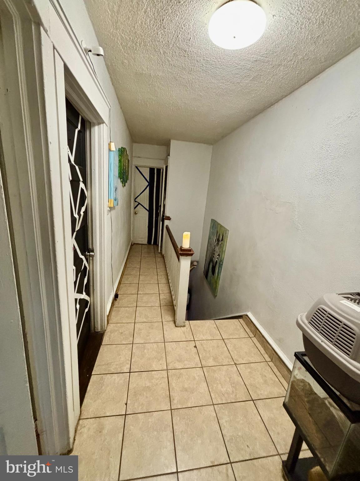 2535 Lindsay Street Chester, PA 19013 - Photo 14 of 22 a view of a hallway with wooden floor and staircase