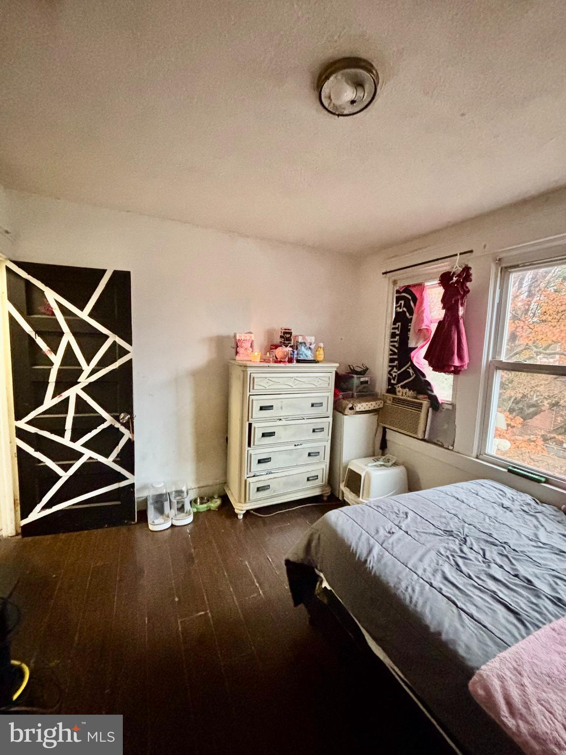 2535 Lindsay Street Chester, PA 19013 - Photo 16 of 22 a bedroom with a bed and a bookshelf with wooden floor