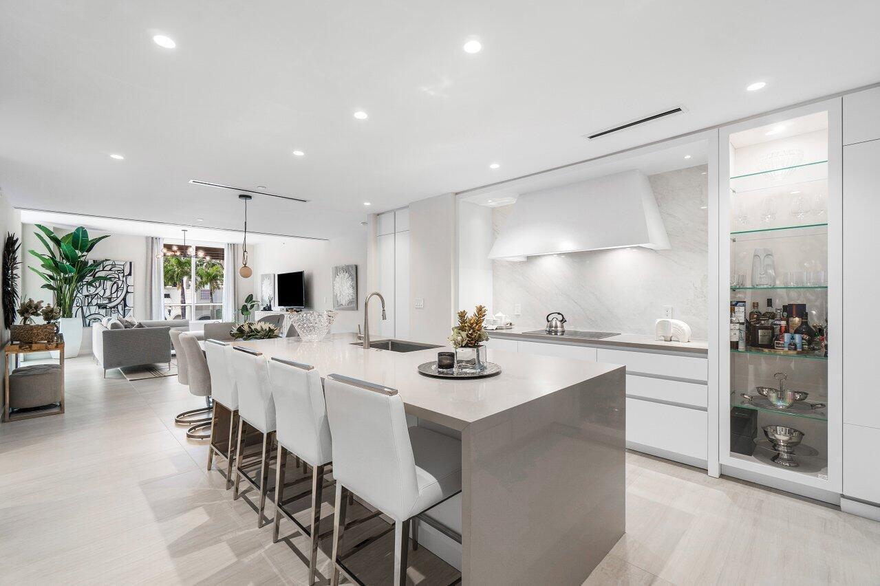 200 Southeast Mizner Boulevard, Unit 211 Boca Raton, FL 33432 - Photo 5 of 67 a kitchen with stainless steel appliances kitchen island granite countertop a sink and cabinets