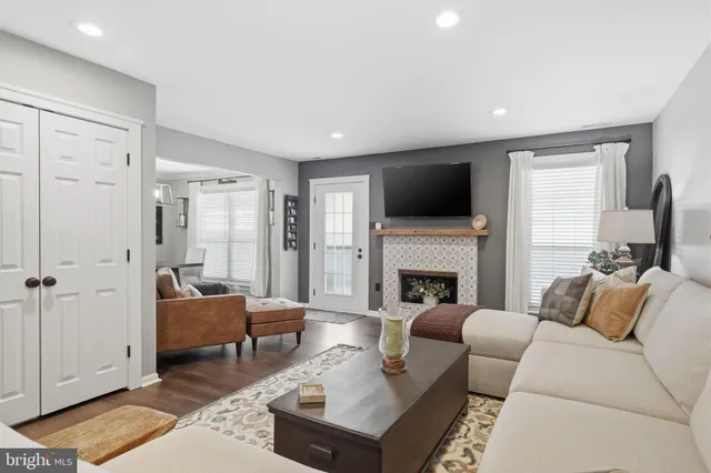 a living room with furniture a fireplace and a flat screen tv