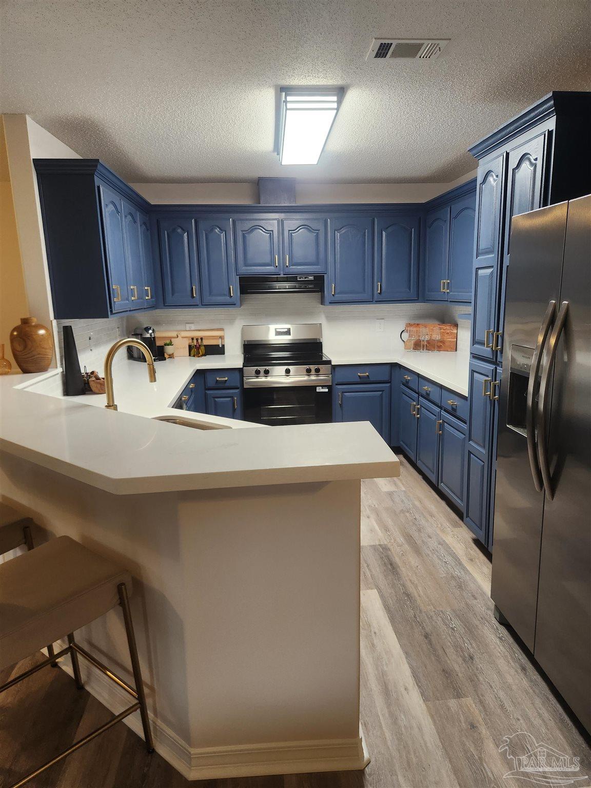 709 Jester Court Pensacola, FL 32506 - Photo 2 of 10 a kitchen with refrigerator a stove a sink and dishwasher