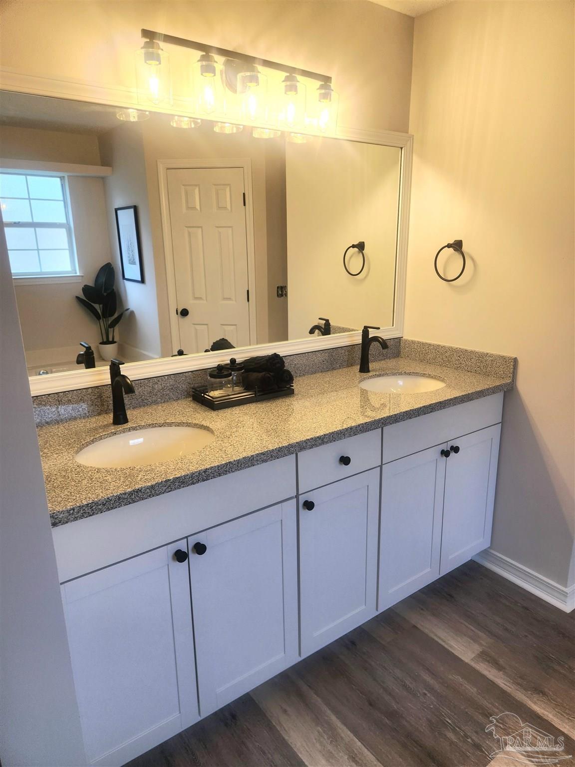 709 Jester Court Pensacola, FL 32506 - Photo 4 of 10 a bathroom with a granite countertop double sink and a mirror