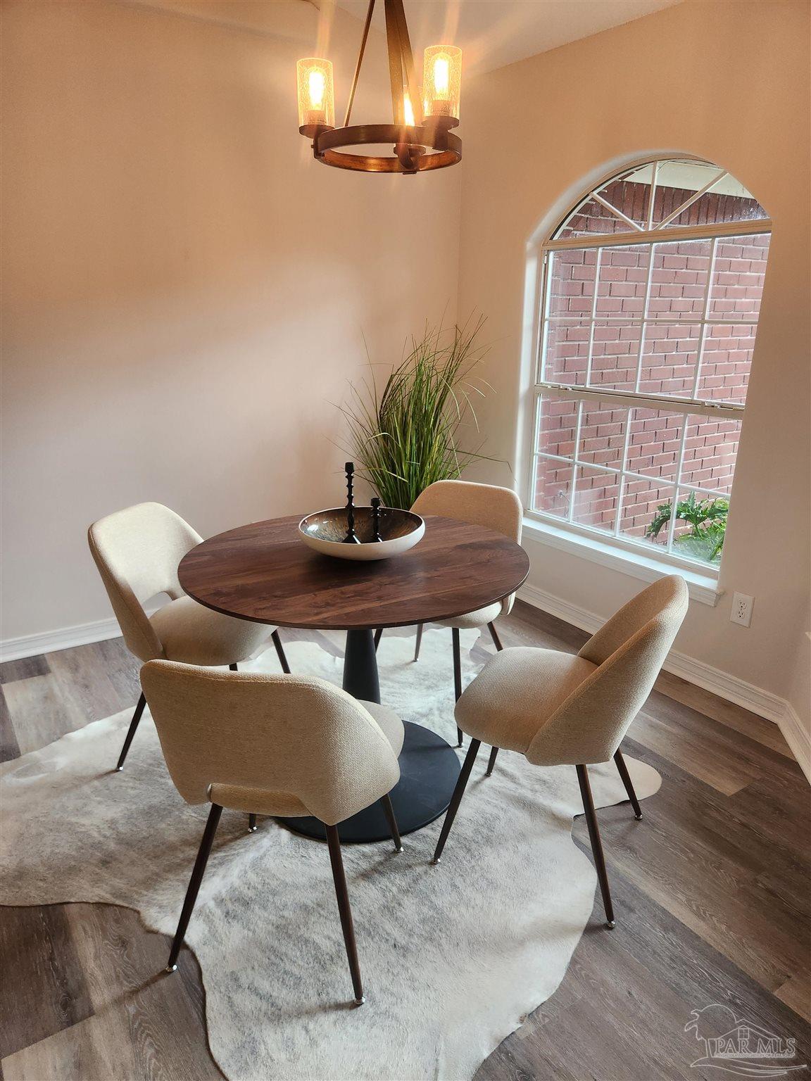 709 Jester Court Pensacola, FL 32506 - Photo 9 of 10 a view of a dining room with furniture and wooden floor