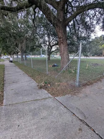a view of a yard with a fence