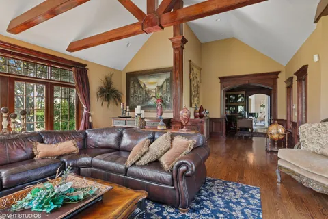 a living room with furniture fireplace and a large window