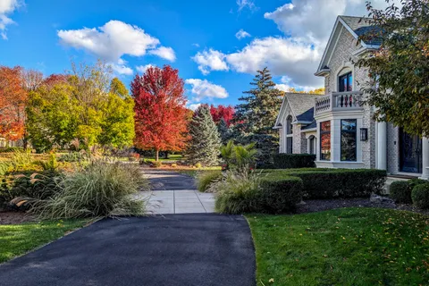 a view of a house with a yard and garden