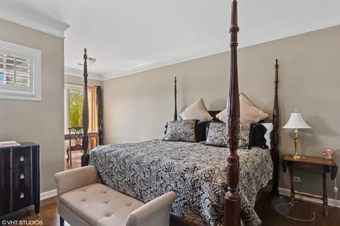 a bedroom with a bed window and chair