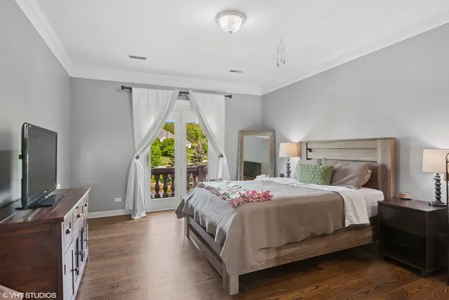 a bedroom with a bed table and flat flat screen tv