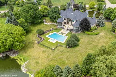 an aerial view of residential houses with outdoor space and swimming pool