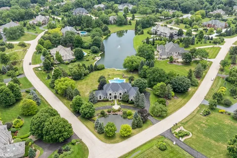 an aerial view of a residential houses with outdoor space