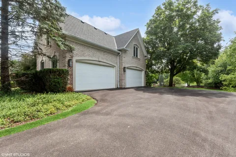 a view of a house with a yard and garage
