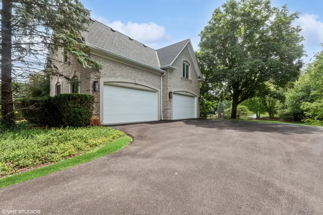 a view of a house with a yard and garage