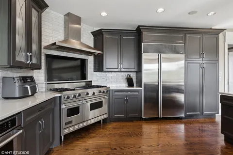 a kitchen with stainless steel appliances granite countertop a stove a refrigerator and a microwave