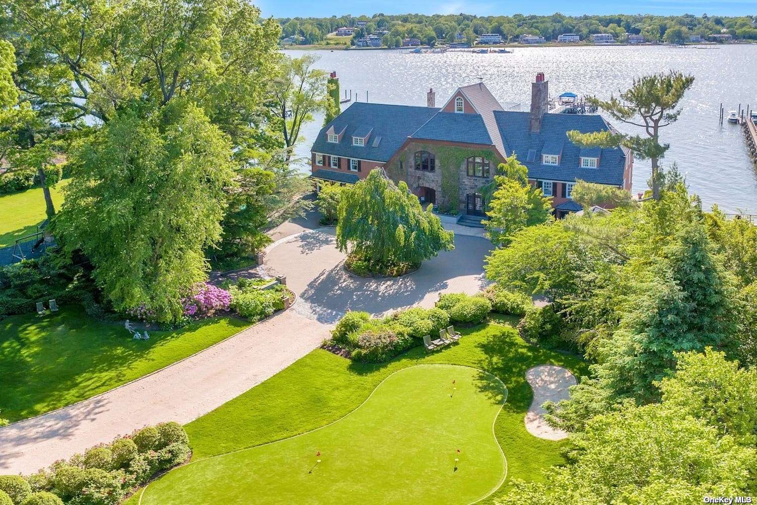 a aerial view of a house with a garden and lake view