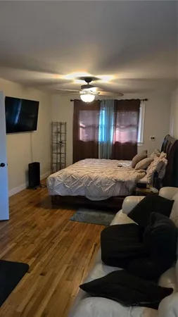 a bedroom with furniture and a flat screen tv