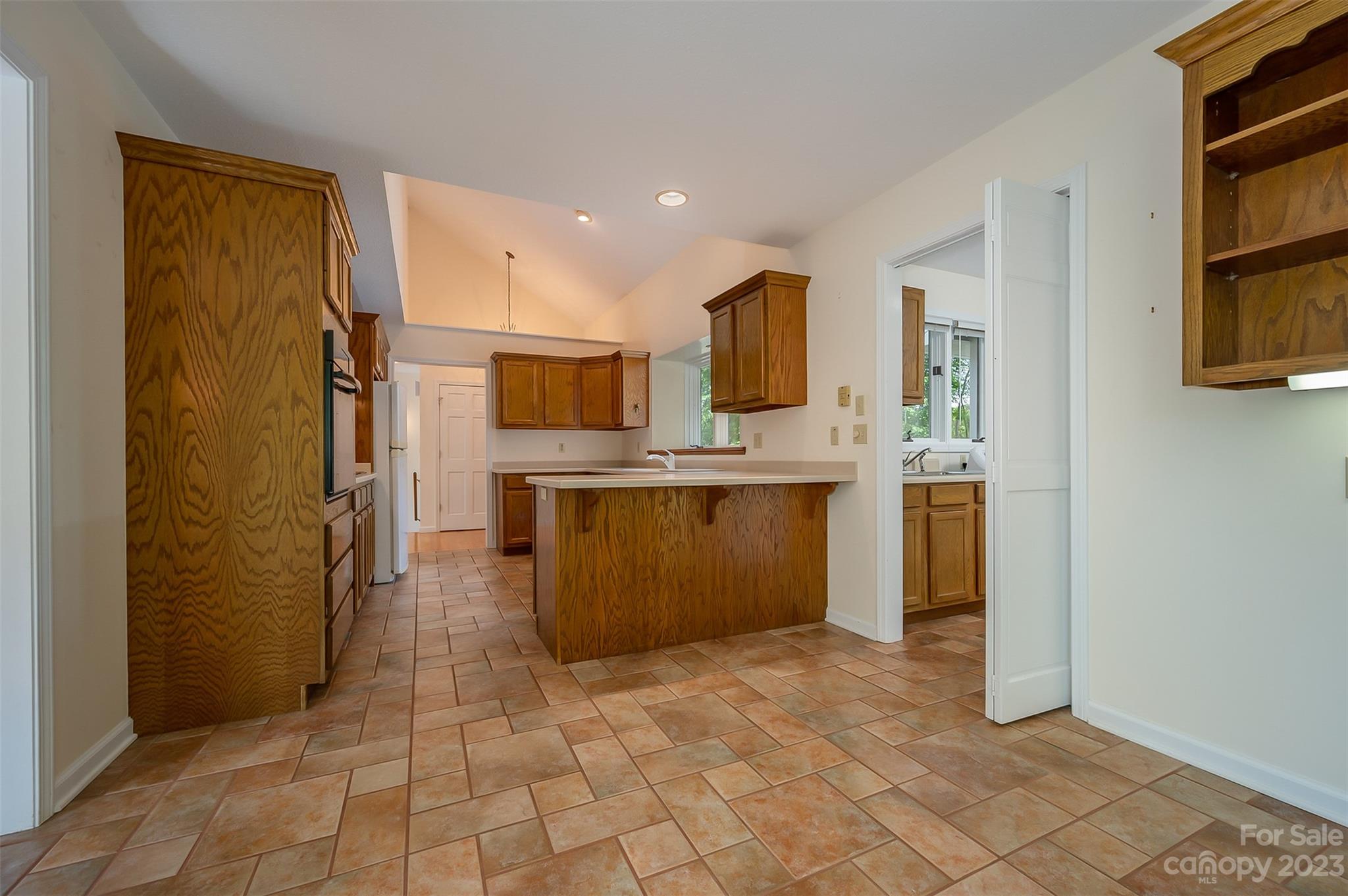 2236 Peniel Road Columbus, NC 28722 - Photo 25 of 48 a view of a kitchen with cabinets and flat screen tv