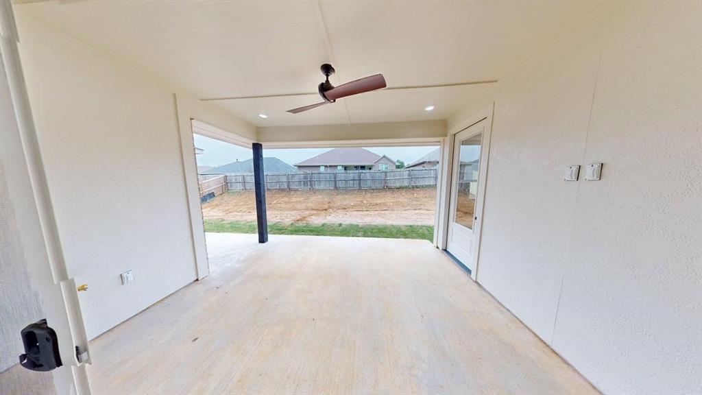 2509 Windmill Lane Longview, TX 75601 - Photo 16 of 35 en empty room with floor to ceiling window and ceiling fan