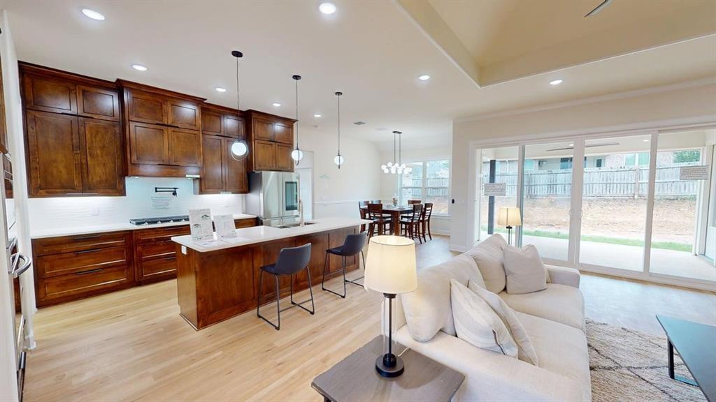 2509 Windmill Lane Longview, TX 75601 - Photo 3 of 35 a large kitchen with stainless steel appliances kitchen island granite countertop a large window and couch