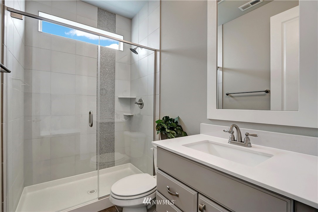 270 Graham Avenue Southeast Renton, WA 98059 - Photo 11 of 17 a bathroom with a granite countertop sink toilet and shower