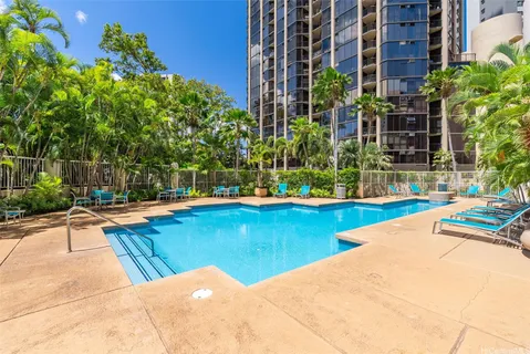 a view of a swimming pool with a lounge chairs