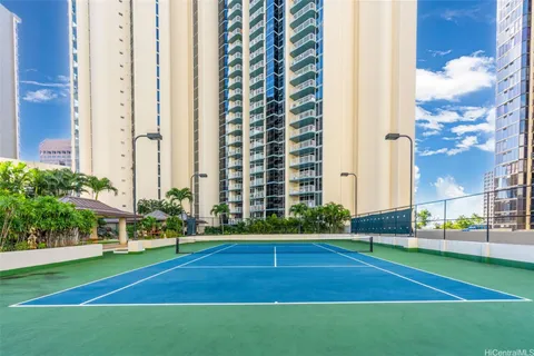a view of a tall building next to a yard