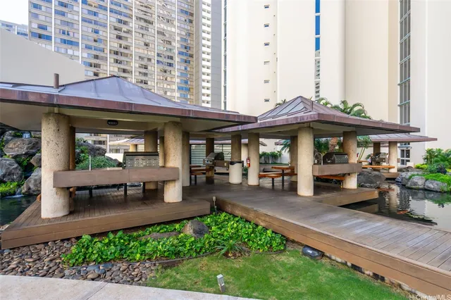 a view of a cafe with a table and chairs under an umbrella