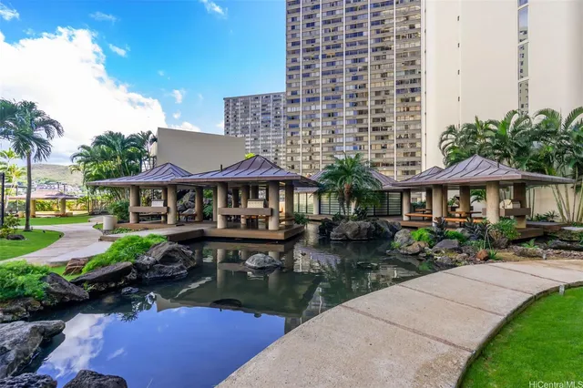 a view of a patio with table and chairs under an umbrella
