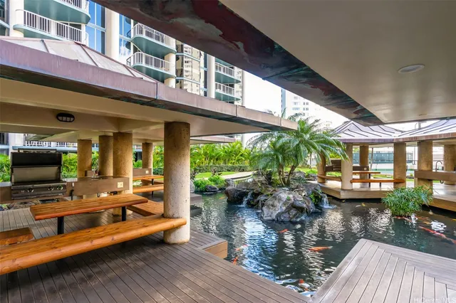 a living room with patio furniture and a fireplace