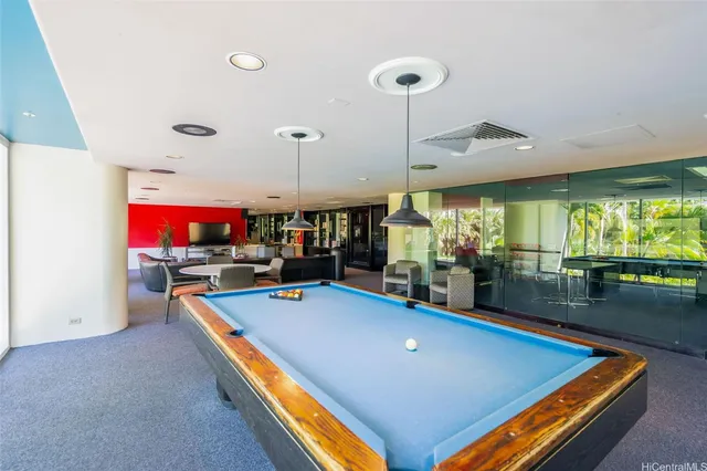 a room with pool table and windows