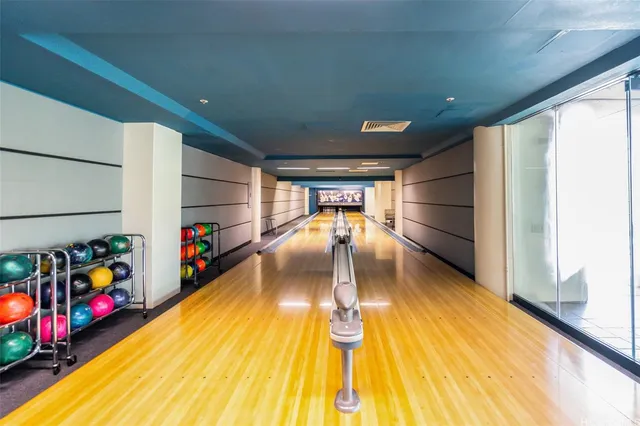 a view of gym equipment with wooden floor