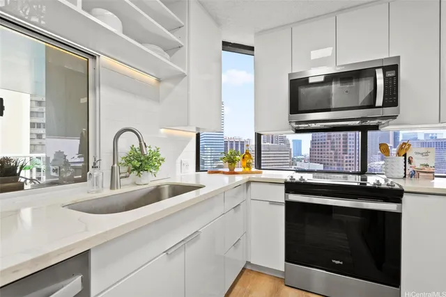 a kitchen with a sink stove and microwave