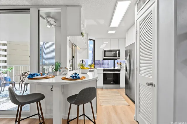 a kitchen with a refrigerator and a stove top oven