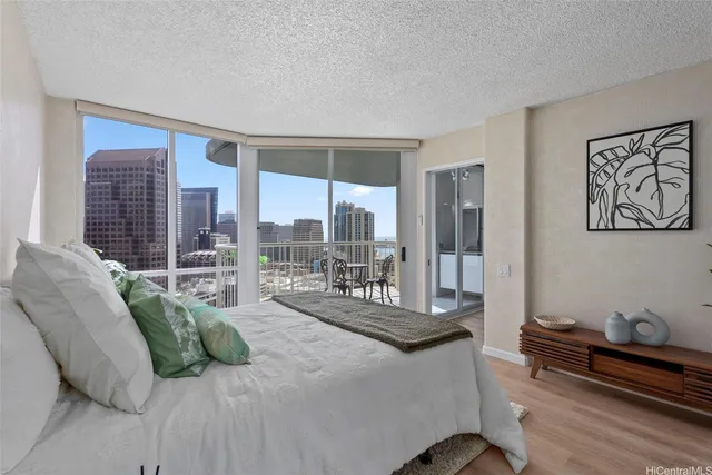 a bedroom with furniture and a large window