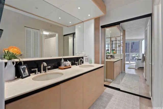 a bathroom with a granite countertop sink a large mirror and a bathtub