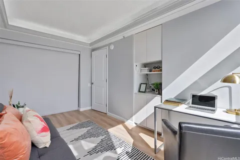 a bedroom with a bed and a computer on the desk