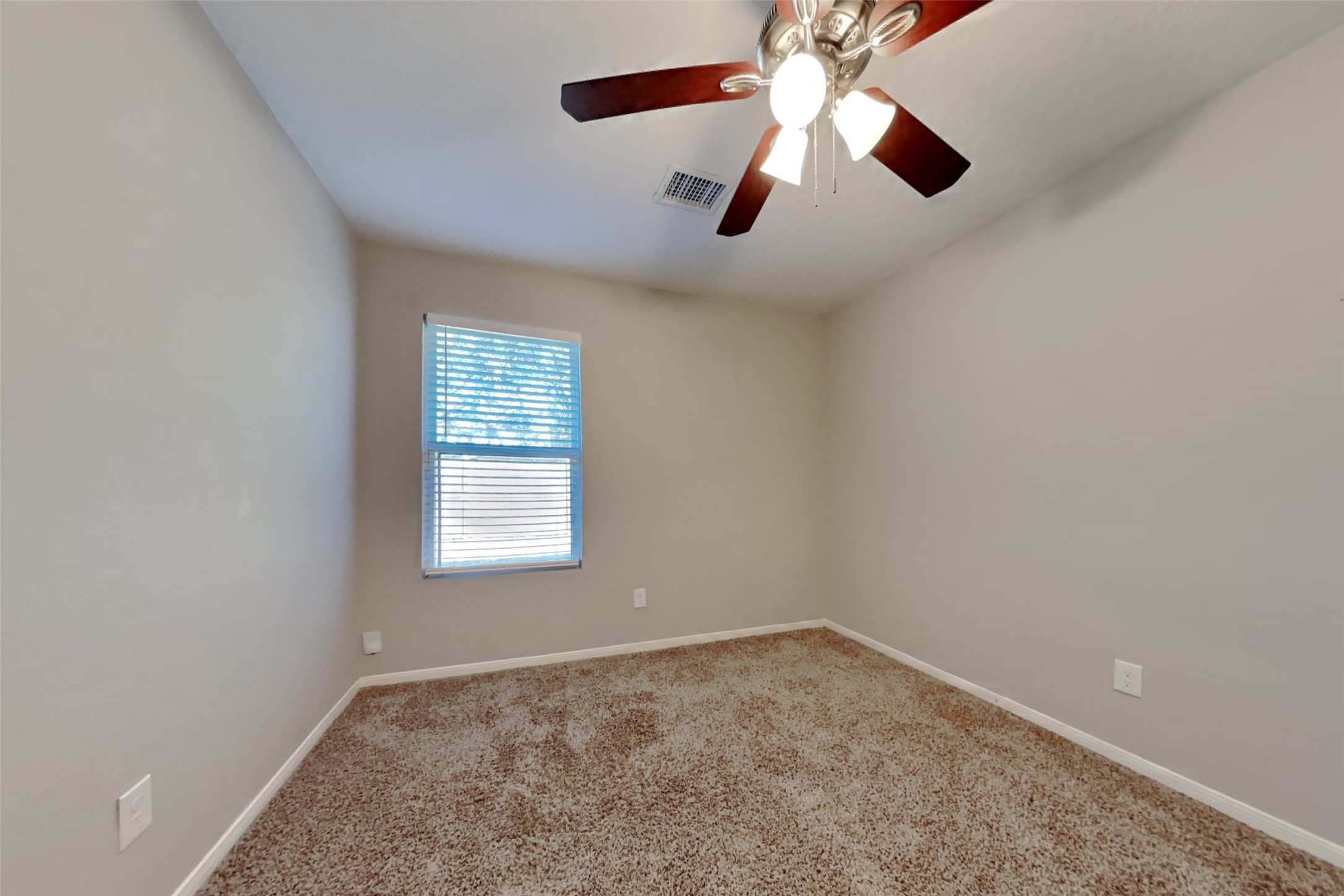 29323 Winton Wood Way Spring, TX 77386 - Photo 13 of 18 an empty room with a chandelier fan and windows