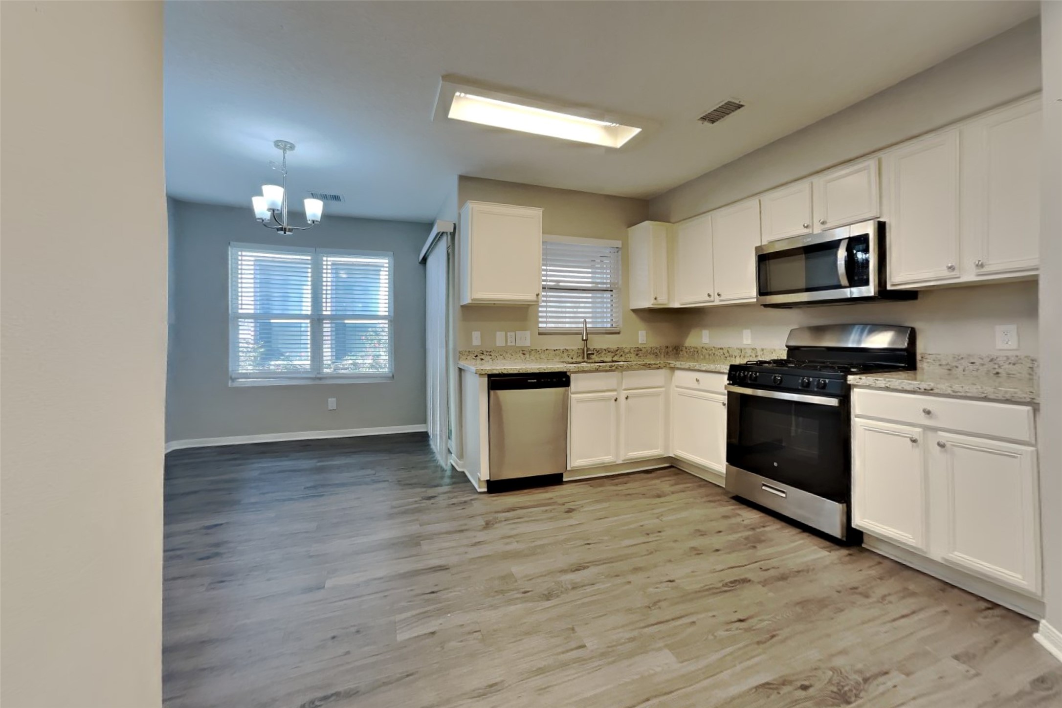 29323 Winton Wood Way Spring, TX 77386 - Photo 6 of 18 a kitchen with granite countertop a stove top oven and cabinets