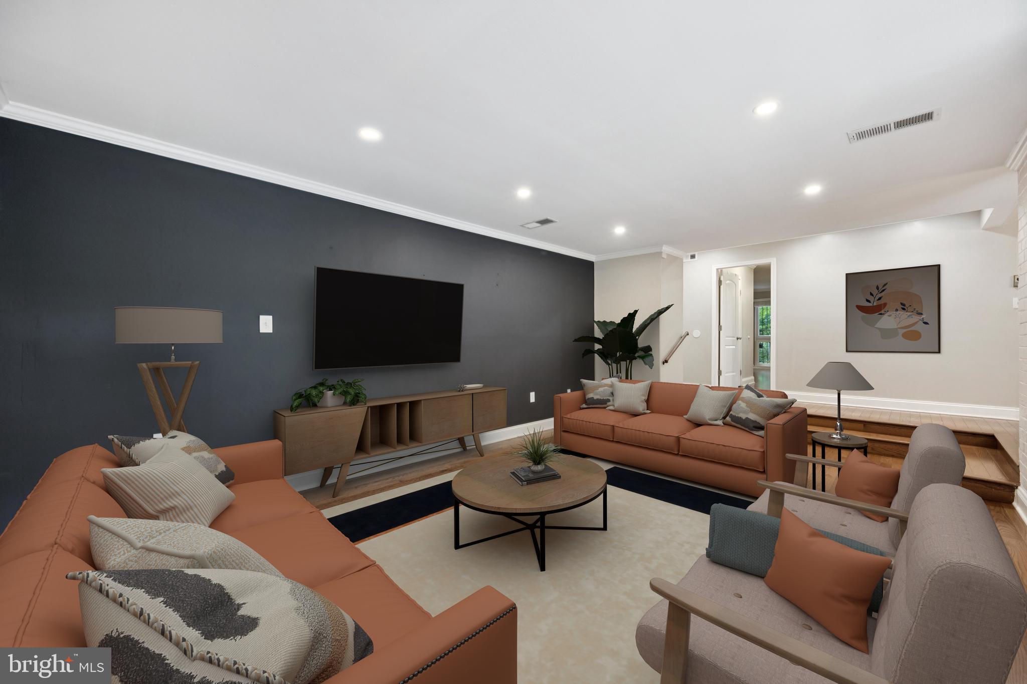 a living room with furniture and a flat screen tv