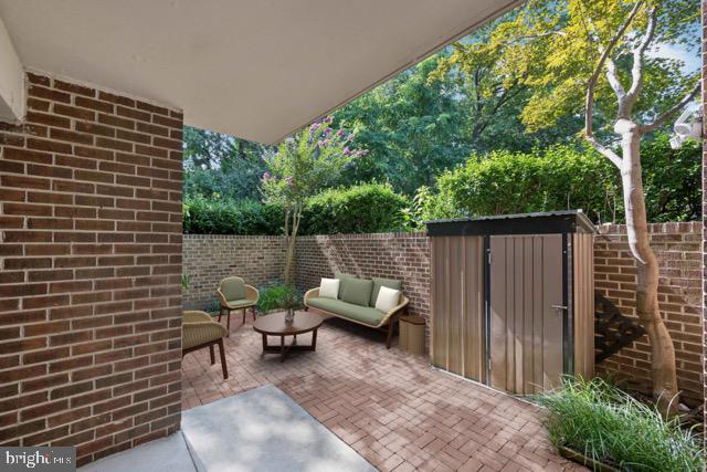 2016 Coleridge Drive, Unit 24102 Silver Spring, MD 20902 - Photo 16 of 19 a backyard of a house with seating space