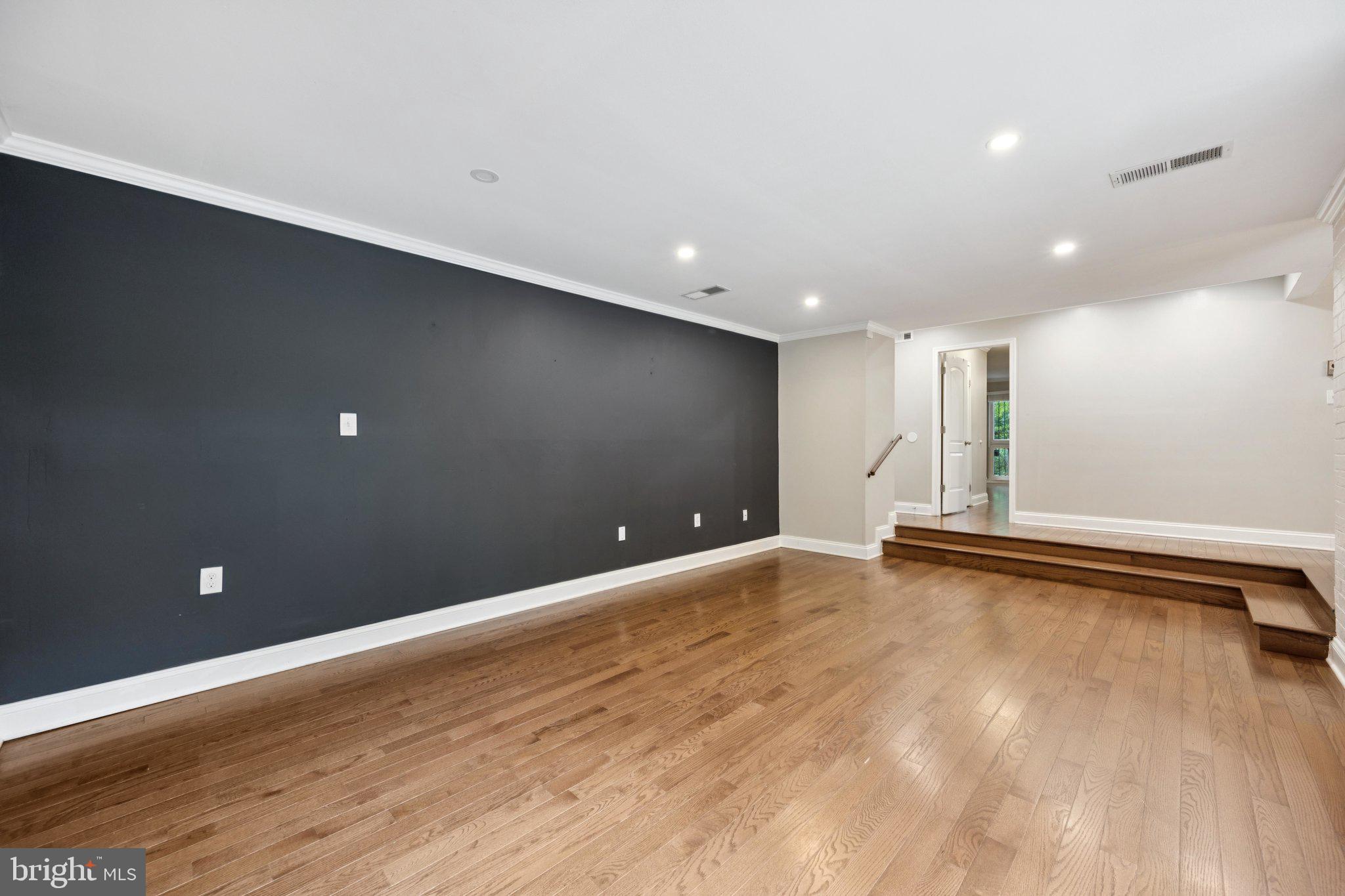 2016 Coleridge Drive, Unit 24102 Silver Spring, MD 20902 - Photo 2 of 19 a view of an empty room with wooden floor