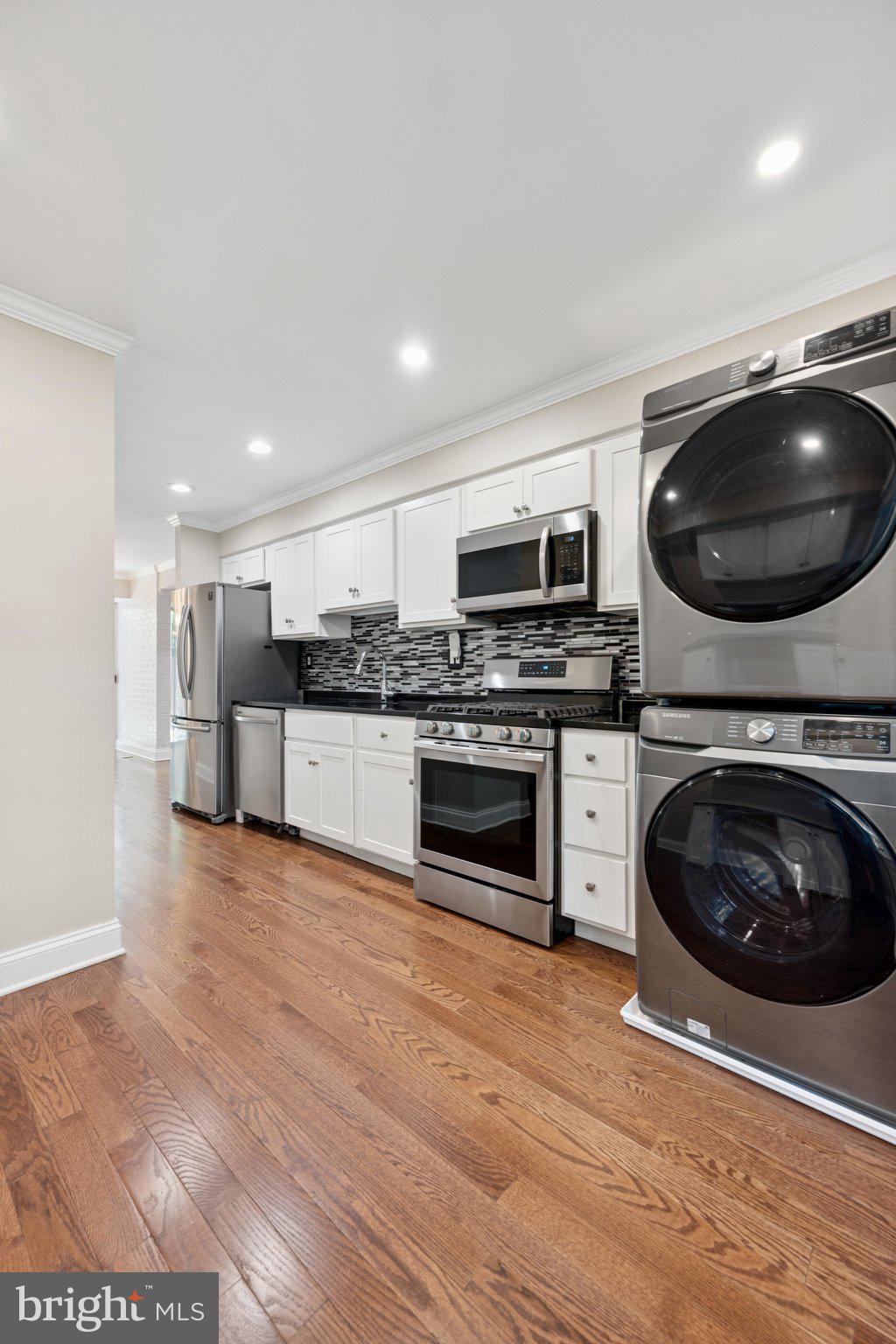 2016 Coleridge Drive, Unit 24102 Silver Spring, MD 20902 - Photo 7 of 19 a kitchen with a stove and a microwave