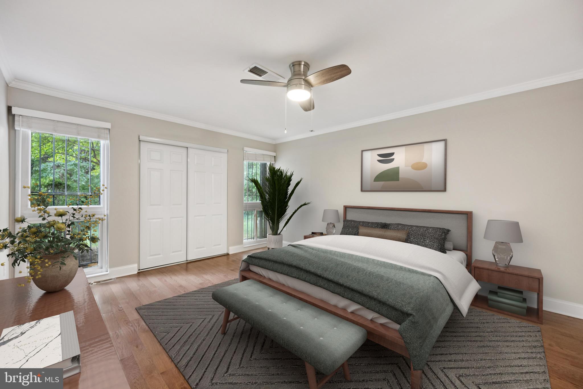 2016 Coleridge Drive, Unit 24102 Silver Spring, MD 20902 - Photo 9 of 19 a bedroom with a large bed and a potted plant