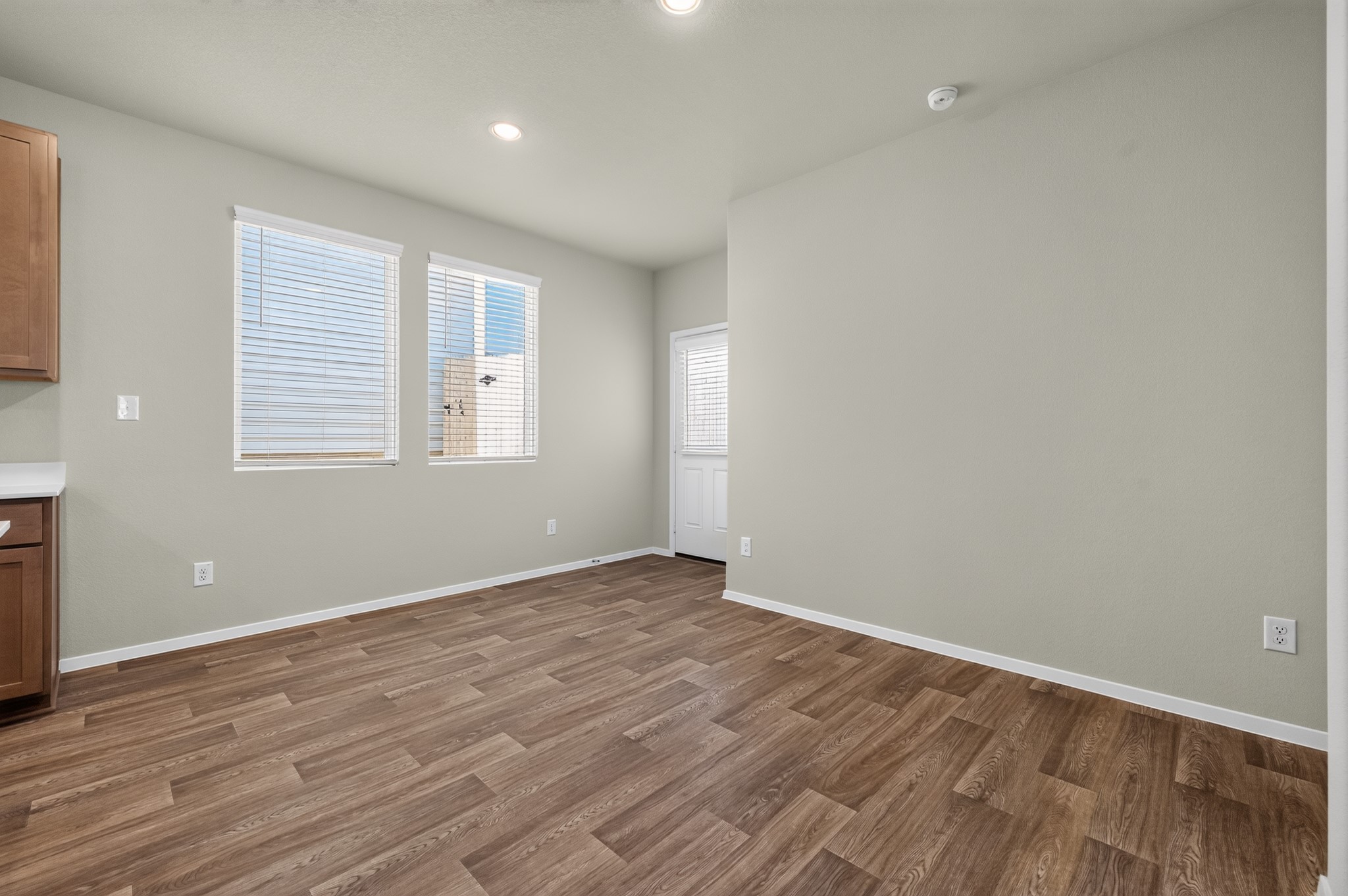2704 Towy Road Manor, TX 78653 - Photo 10 of 36 Gleaming wood-look floors complement the light-filled dining space next to the kitchen area.