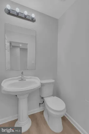 a bathroom with a sink a toilet and mirror