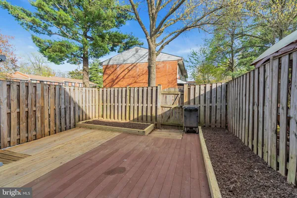 a view of backyard with a deck and wooden floor