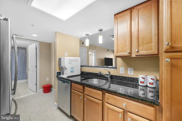 a kitchen with stainless steel appliances granite countertop a sink and cabinets